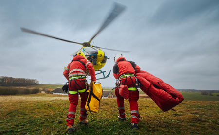 Search and rescue workers go toward a helicopter